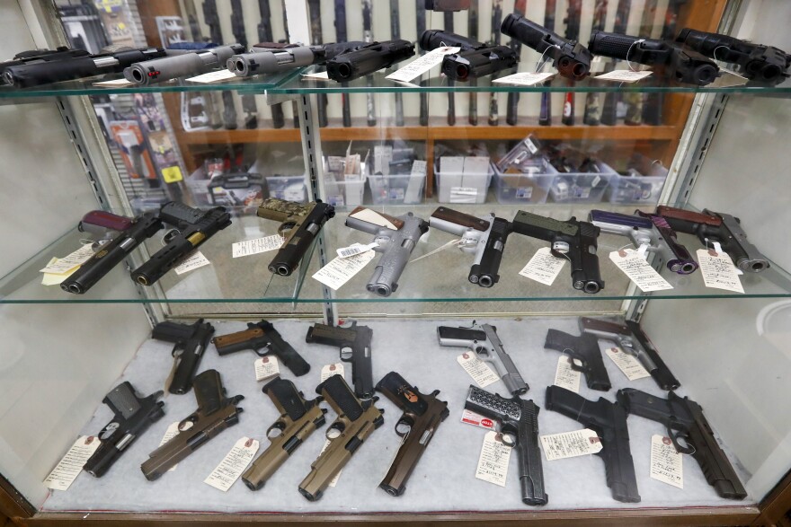 FILE - In this March 25, 2020, file photo semi-automatic handguns are displayed at a shop in New Castle, Pa. (AP Photo/Keith Srakocic, File)