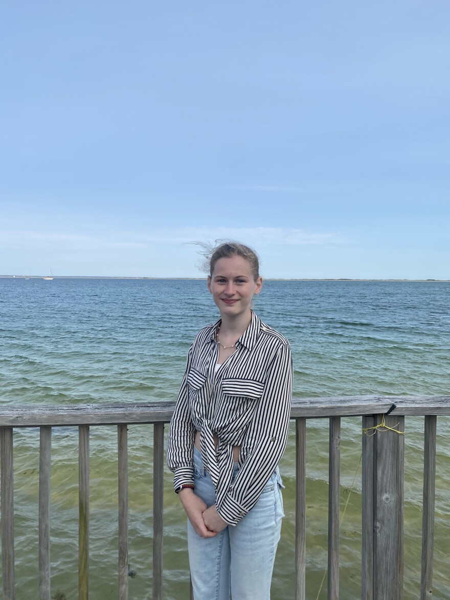 Provincetown IB Schools student Bella Wertwein stands by the beach in front of her old house, which was floated across the inlet. June 2, 2025