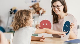 Emotion emoticons used by a psychologist during a therapy session with a child with an autism spectrum disorder.