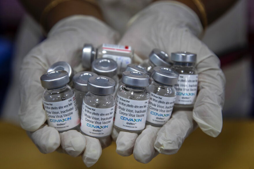 FILE - In this May 8, 2021, file photo, a health worker displays empty vials of COVID-19 vaccines in Gauhati, India. The disparities of the coronavirus pandemic were already stark in India, where access to health care is as stratified and unequal as other parts of its society. Now, the divide along the lines of wealth and technology are further widening that chasm, and many people are falling through the gaps as vaccines remain inaccessible to millions. (AP Photo/Anupam Nath, File)