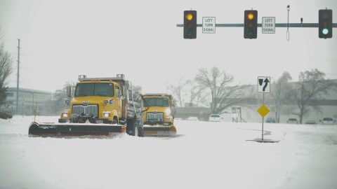 Missouri Department of Transportation snow plows make the turn from Independence Avenue and Strother Road toward I-470 in Lee's Summit on Jan. 5, 2025.