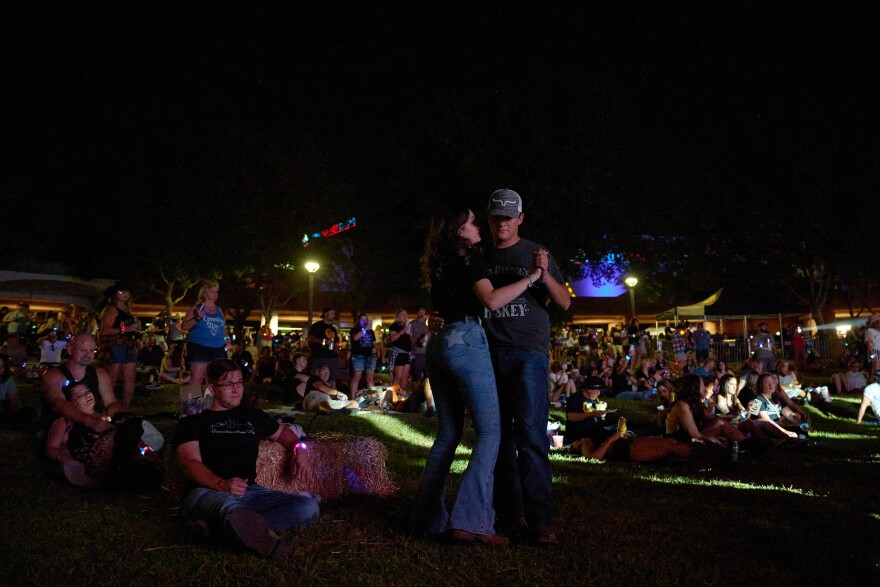 Ashley Auakian and Hunter Curland dance during Remember Music Festival at Clark County Government Center Amphitheater in Las Vegas, Nevada on Oct. 1, 2022.