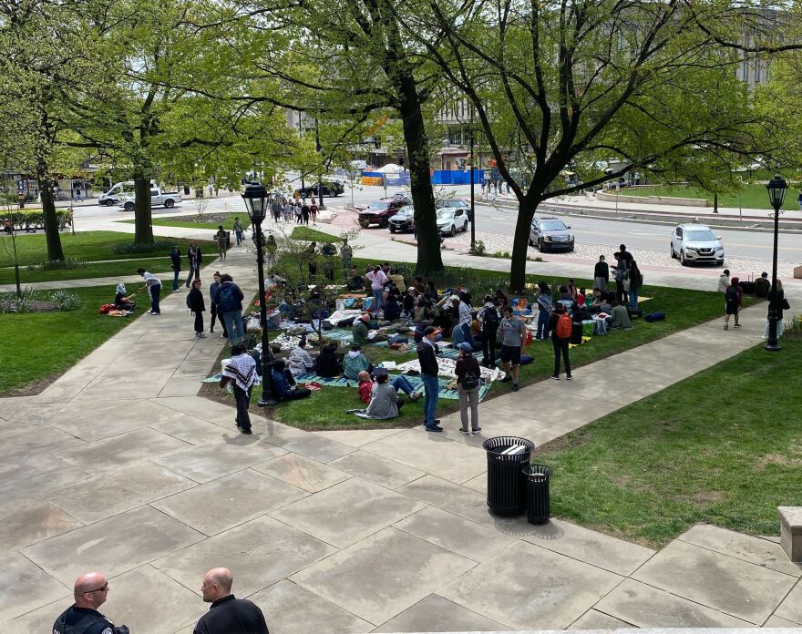 Pitt student protesters were moved from inside of the Cathedral of Learning to outside, where they set up on a patch of grass near Bigelow Boulevard.