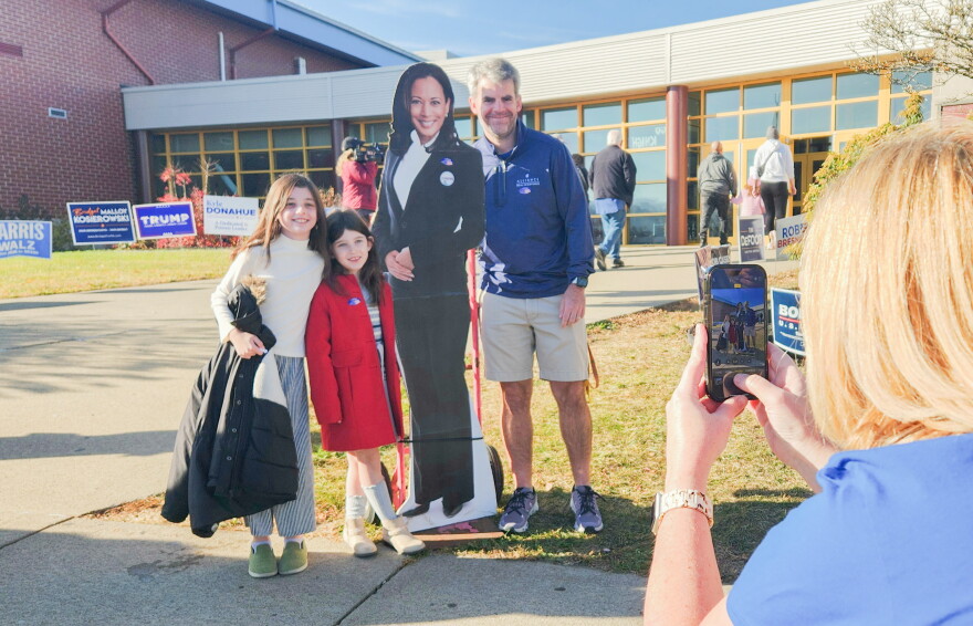 The McCormick family of Scranton poses for a photo with a cutout of Democratic presidential nominee Kamala Harris outside Scranton High School on Tuesday morning.