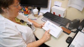 Kathy Howard, who has worked as a sexual assault nurse examiner for decades, shows an unused rape kit.