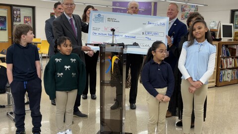 Modern Automotive President Rob Fowler and members of the community coalition All In For Our Schools presented a $1.4 million check for the district at Bolton Elementary School on Jan. 6, 2026.