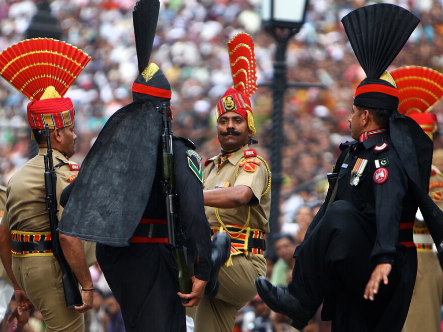 Pakistani Rangers (in black) goosestep at the Wagah border; India's border guards are in tan. The 30-minute ritual show of force and bluster happens every evening of the year. Hundreds of spectators come to watch the show -- from both sides of the border.