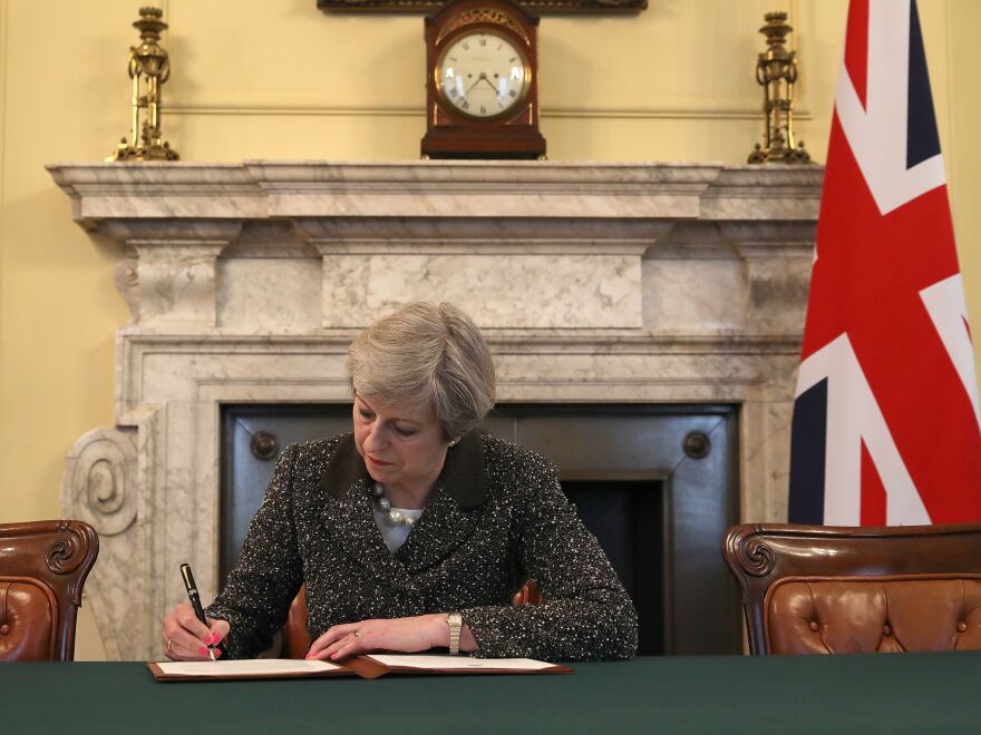 Britain's Prime Minister Theresa May signs the official letter to European Council President Donald Tusk invoking Article 50 and signaling the United Kingdom's intention to leave the EU.