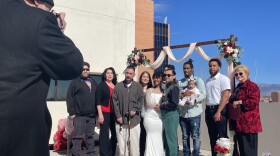 Jesse Muñoz and Reianna McEachron pose for a picture with family and friends after getting married at the Bernalillo County Clerk's Office on February 14th, 2024.