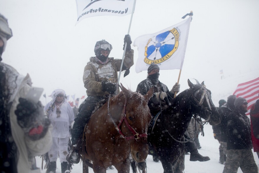 "Water protectors" and veterans march to the front lines at Backwater Bridge on Monday.