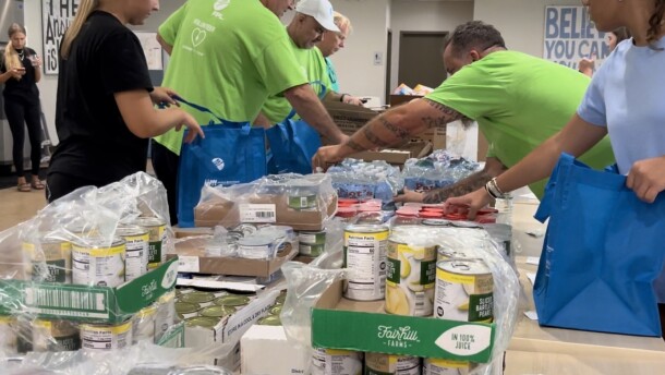 FPL and Community Cooperative volunteers assemble hurricane meal kits for seniors who may not be able to leave their homes immediately after a storm. Each kit includes three days of shelf-stable food, water and snacks.