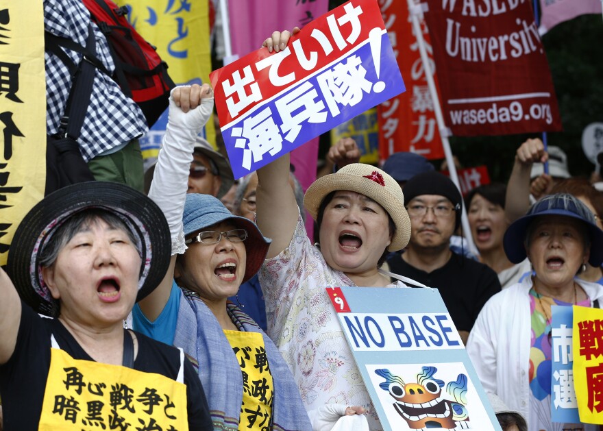 Anti-U.S. base protesters shouts slogans at Sunday's rally.