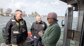 Officials survey lake levels in Sodus Point on Thursday.