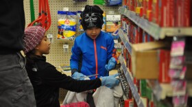 Mia Fernandez, 9, and her brother Mason, 6, help clean up inventory at an ACE Hardware in Eureka with their father, Danny.