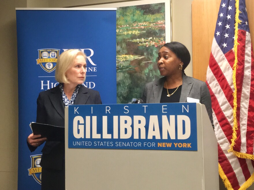 Sen. Kristen Gillibrand, D-N.Y. looks on as Candace Lucas, director of St. Joseph's Neighborhood Center, speaks at the press conference where Gillibrand announced a new bill to expand federal health care coverage.