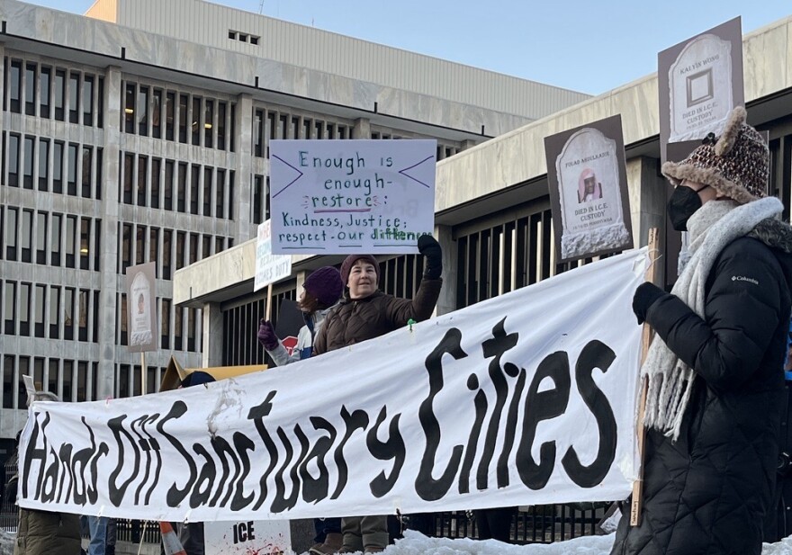 Dozens of demonstrators who rallied on Monday evening, March 2, 2026, outside the Kenneth B. Keating Federal Building and U.S. Courthouse on State Street in downtown Rochester.