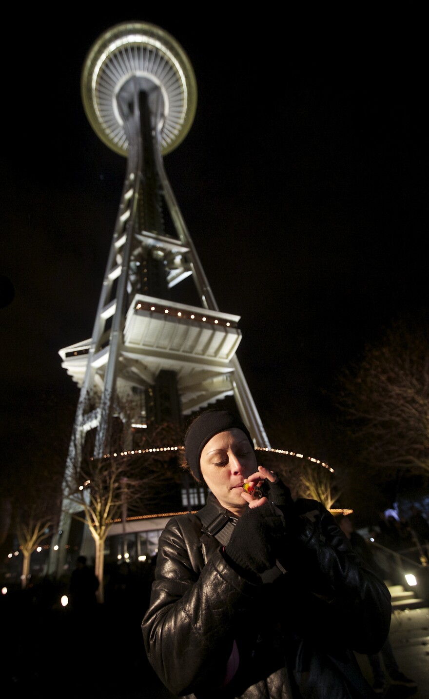 Robyn Bowen of Seattle Washington smokes marijuana underneath the Space Needle shortly after a law legalizing the recreational use of marijuana took effect on Thursday.