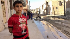 A few families are returning to heavily damaged neighborhoods on the outskirts of Mosul's old city. The residents must be cleared by a committee that certifies they are not ISIS members before they start to move back to repair their homes.