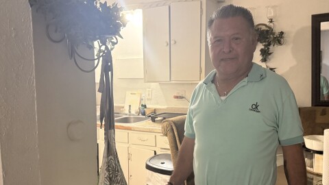 Wen Becerra stands in his dining room Wednesday after being told he will have until the end of the month to move.
