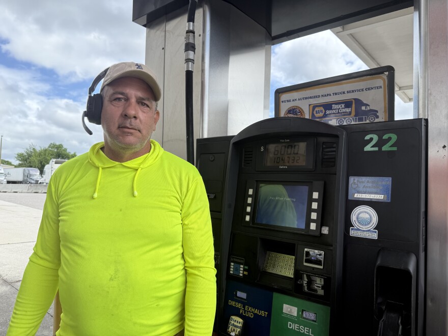 A trucker stands in front of a pump at Tampa Truck Stop off of U.S. 301. 