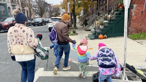 Julia Battista (far left) and Jason DiNovi (middle) cross the streets with the children, keeping an eye out obstructions and oncoming traffic.