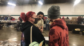 A vendor shows off a lizard to enthusiasts at the Exotic Pet Exposition in Springfield