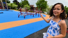 Camila Pena, 10, points to an area of the playground at John F. Kennedy Elementary School that uses a part of her design.