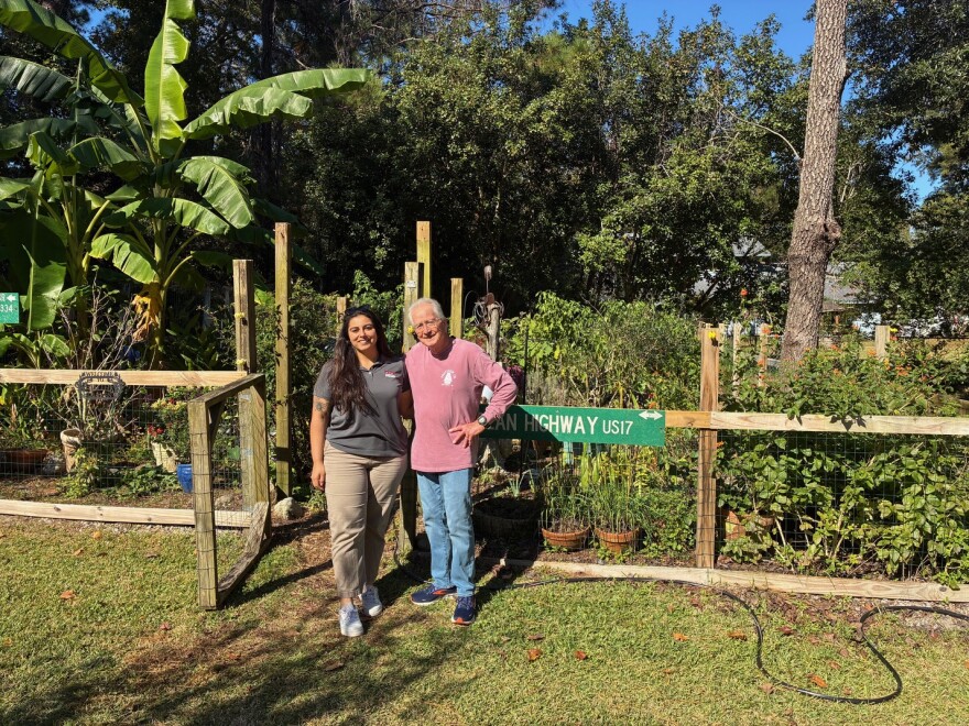 Gabriella de Souza poses with her uncle, David Miller. Both are gardening savants.