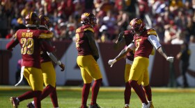 Washington Commanders linebacker Dante Fowler Jr., right, celebrates his sack of Cleveland Browns quarterback Deshaun Watson (not shown) during the second half of an NFL football game in Landover, Md., Sunday, Oct. 6, 2024. (AP Photo/Nick Wass)