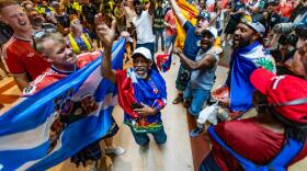 Scottish and Haitian fans dance and chant together inside South Station before a World Cup match in Foxborough. (Jesse Costa/WBUR)