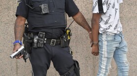 Atlanta Police officers detain a man after finding a hand gun in his backpack during a protest, Friday, May 30, 2020 in Atlanta. The protest started peacefully earlier in the day before demonstrators clashed with police. (Mike Stewart/AP)