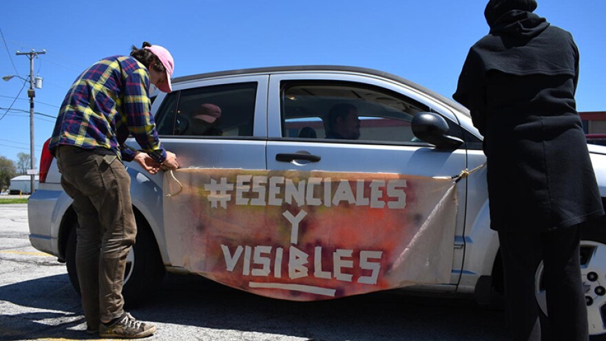 Demonstrators hang a banner from a car before the protest in Elkhart, Indiana.
