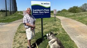 Brian Friedman and his dog Sky stand by the new public open space at the former Lambert's Point Golf Course on Monday, April 15. (Photo by Katherine Hafner)