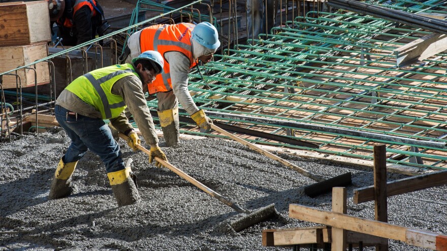 Construction workers in Washington, D.C., in December. The latest jobs report will further drive the "misery index" to its lowest level in more than half a century. But economists say meager wages and big debts are still problems.