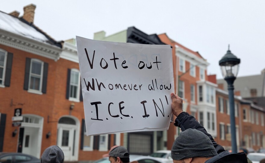 A protester holds up a sign that reads "Vote out whomever allow ICE in!" in Washington County, Md on February 10, 2026.