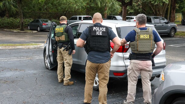 federal officials outside a car  