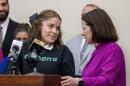 Student Lissy Alonzo looks to Holly Boffy, then president of Louisiana’s school board, while trying to deliver a statement during a press conference on Dec. 4, 2023 at the Claiborne Building in Baton Rouge, Louisiana.