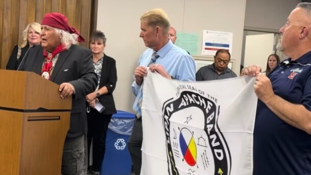 Richard Gonzalez, chief of the Lipan Apache Band of Texas, presented the tribe’s flag to Sanger High School on May 26, 2026, after the school obtained permission to continue using the Apache as its name and mascot.