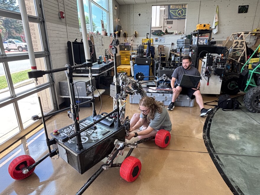 Missouri S&T students Abby Frerking and Will Weidler work on Talos, the Mars rover their team designed and built that won the 2025 University Rover Challenge.