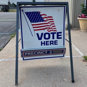 A sign reading "vote here" directs people to Blair Township's Precinct Number 2, on August 2, 2022.