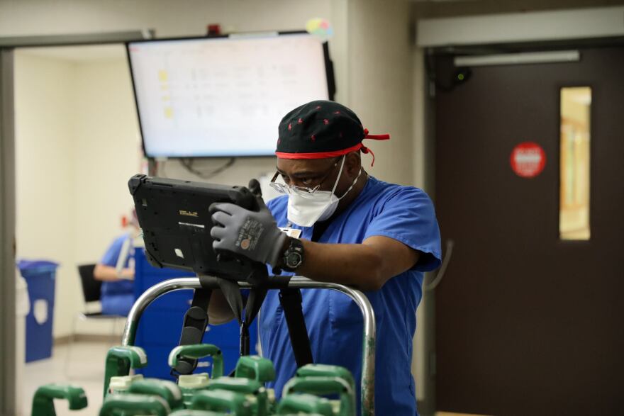 A hospital employee works in the Barnes-Jewish Hospital Intensive Care Unit in April. The hospital has resumed scheduling elective procedures. 