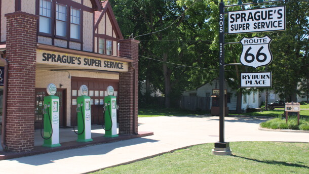An entrance to Sprague's is seen, with replica gas pumps and a welcome sign.