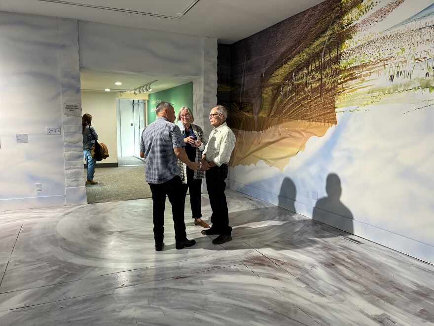 Members of the SLO Museum of Art standing in the middle of Hoffman's exhibit