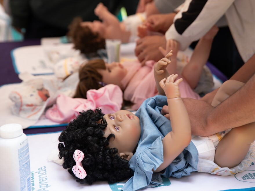 Changing a diaper is one of the fundamental skills that men learn at the Care School.