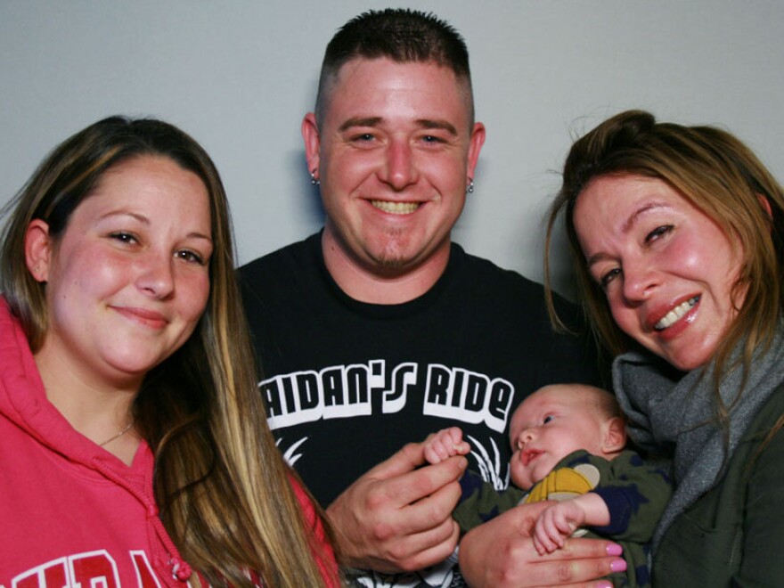 Elisa Seeger holds Matthew Hunter, with his parents, Nick and Lindsay Hunter.