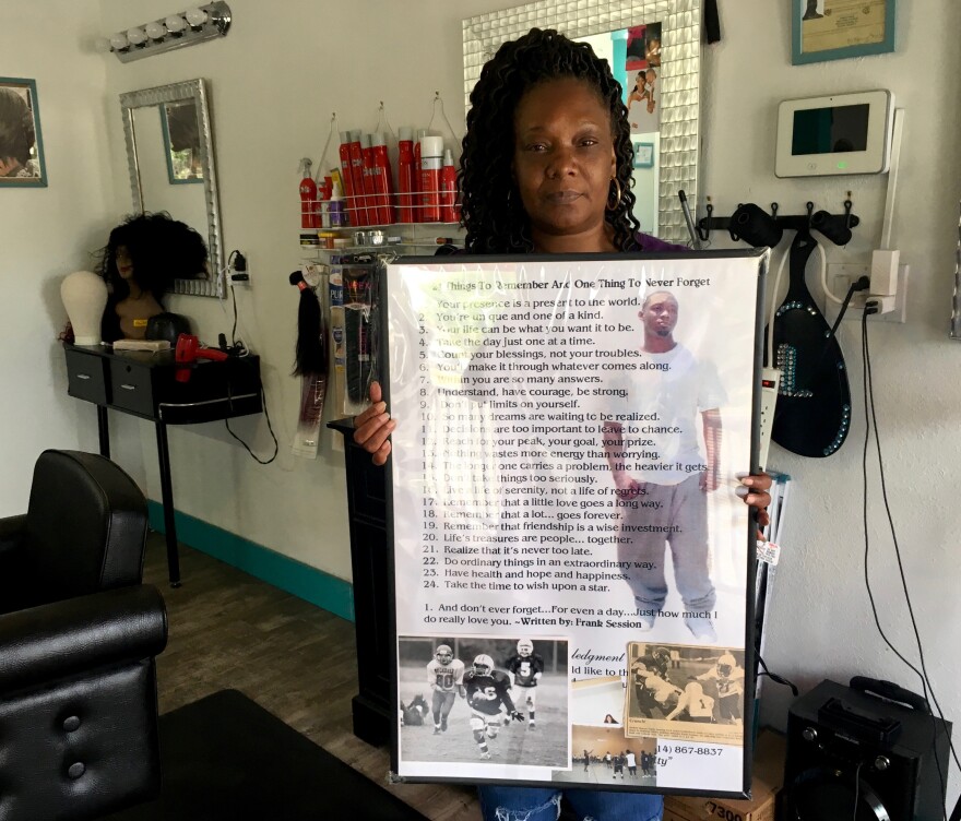 Tammy Riley holds a poem by her son, Frank at her daughter's beauty salon in the Greater Ville neighborhood. Frank died in a shooting outside a north St. Louis bar in 2009.