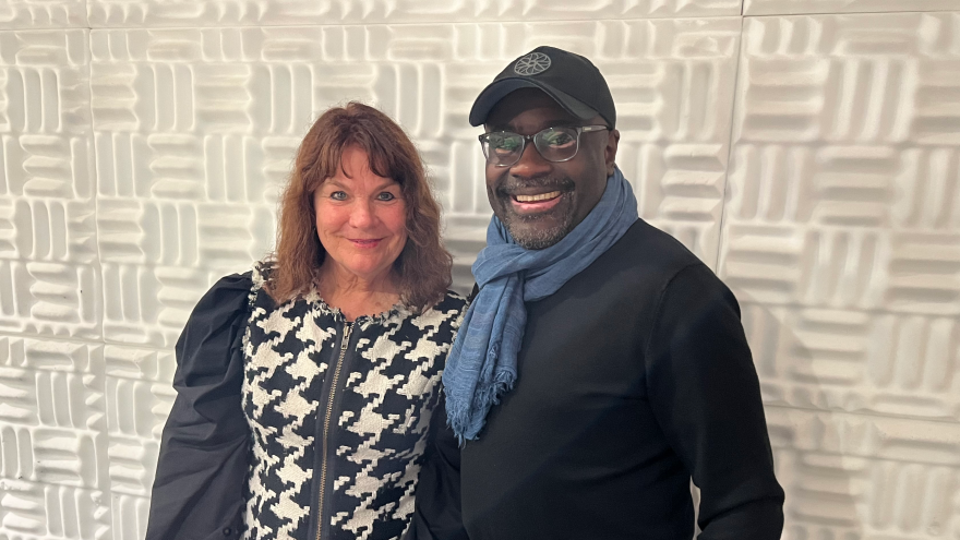 Lisa Ledin and John Wineglass pose next to each other in the KAZU studio. 