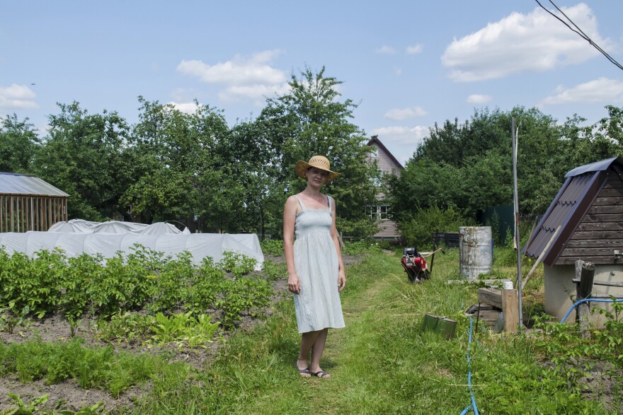 Natalya, a Moscow schoolteacher, stands outside her family's country home. "I can't imagine my life without this place," she says.