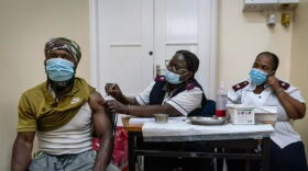 A man is vaccinated against COVID-19 at a clinic in Johannesburg, South Africa, on Dec. 6. The omicron variant appears to be driving a surge in South Africa. New studies suggest that vaccines might not be as effective against this variant but that a booster shot can be helpful.