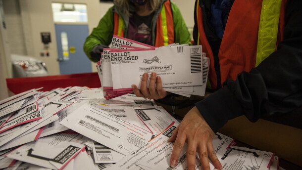 FILE: Election worker Kristen Mun from Portland empties ballots from a ballot box at the Multnomah County Elections Division Tuesday, Nov. 3, 2020 in Portland, Ore.